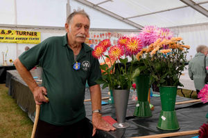 Robert (Bob) Lewis of Craven Arms with some of the prize winning flowers he produced and entered into Kington Show’s competitions. Bob grows vegetables and flowers at his home and he has entered the show since the 1970’s. He was previously a head shepherd with Clun Forest Sheep and then became a market trader for 40 years. Image by Andy Compton
