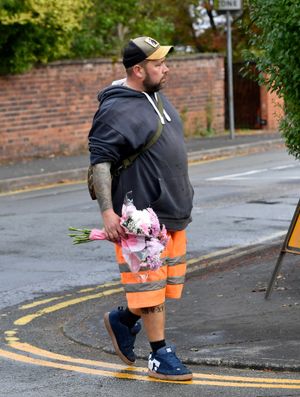 Neighbour Ben Lowe visits the cordon on Corporation Street in Stafford to lay flowers in memory of the two children who died on Sunday. Photo: Tim Thursfield