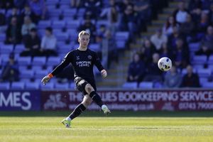 Shrewsbury Town goalkeeper Matt Cox clears 