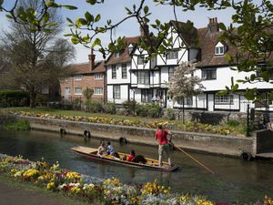 People enjoy punting on the Great Stour through Westgate Gardens in Canterbury, Kent, during the sunny weather