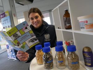 Grace Leslie final year student at Harper Adams University reading a mini guide by the crops challenge at Royal Welsh Winter Fair and talking about degrees at the university near Shropshire. 