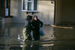 Residents walk through flooding in Wraysbury, Berkshire.
