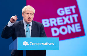 Boris Johnson on stage giving his speech at the Conservative Party Conference at the Manchester Convention Centre
