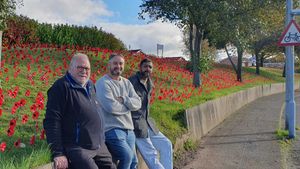 Councillors Pete Lee, Paul Bradley and Kamran Razzaq pose in front of the poppies. Photo: Amblecote news from Paul, Pete and Kamran