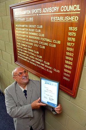 Peter Holmes, with his certificate for his sixty years service to sports in Wolverhampton. He is pictured at Aldersley Stadium.