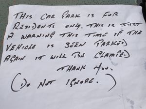 Supporting image for story: 'Residents only': Clamp warning left on police car as officers help 94-year-old burglary victim