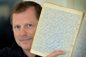 Geoff Southall-Owen with one of his grandfather's notebooks