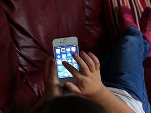 A child using an Apple iPhone smartphone