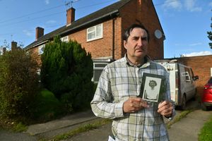 Neville Pass, outside his Shrewsbury home with a photograph of his mother, Doreen Pass