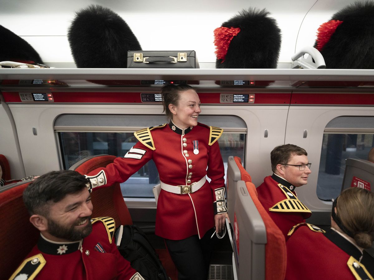 In Pictures: Bearskin caps in the luggage rack as Coldstream Guards return home