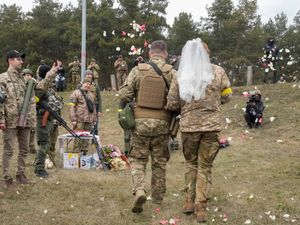 Supporting image for story: Ukrainian volunteer troops marry in military fatigues at Kyiv checkpoint