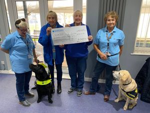 Presentation time – the Albrighton cheque is handed over to the Telford Guide Dogs group and two ambassador dogs