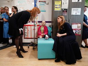 Sarah, Duchess of York and her daughter Princess Beatrice speak to a young cancer patient, Lola Belle Tucker, during a visit to the Teenage Cancer Trust unit at University College Hospital