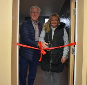 John Richards and Julie cut the ribbon to officially open the Latham Room