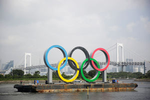 The Olympic rings are moved from their spot in Tokyo Bay for maintenance, ahead of the postponed Games