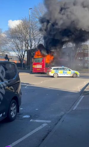 The bus could be seen well ablaze as police blocked the road. 