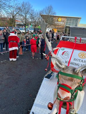 Caption: Santa is greeted by children and parents at Dobbies Garden Centre.
