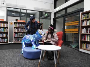 Supporting image for story: Lights go back on at library torched during riots