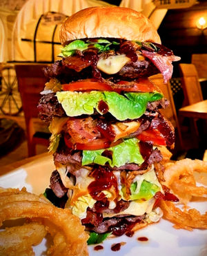 The Mighty Stacker contains eight steak burgers with Monterey jack cheese and bacon strips, as well as onion rings