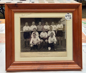 A framed photograph of Bert with the England team
