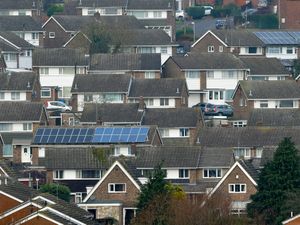 Rooftops, including solar panels, seen from above