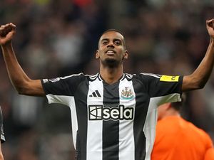 Alexander Isak holds his arms out to celebrate scoring