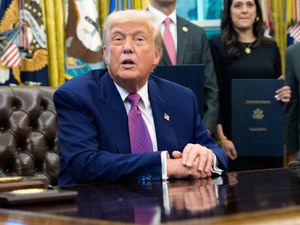 President Donald Trump speaks with reporters