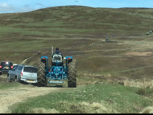 The trail of tractors on the way up the Beacon hill