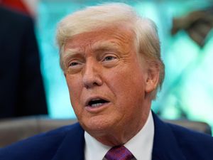 President Donald Trump speaks with reporters