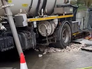 Supporting image for story: How do you rescue a tanker stuck in a sinkhole? 20 tons of stone and a few railway sleepers should do the trick