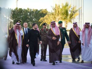 Volodymyr Zelensky walking with Prince Saud bin Mishaal and others