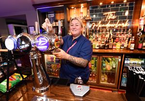 Staff member Amanda Warriner works on pouring a pint of Carling