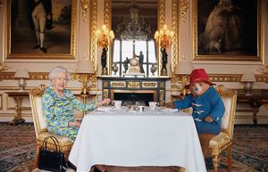 Queen Elizabeth II and Paddington Bear having cream tea for a film that was shown at the BBC Platinum Party at the Palace