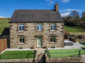 Hollydale House in Leek, Staffordshire — the flagship property at Hollydale Cottages. The luxury countryside retreat features a private hot tub, outdoor dining area, and panoramic Peak District views. Recently recognised at the 2025 Sykes Gems Awards for its outstanding guest experience