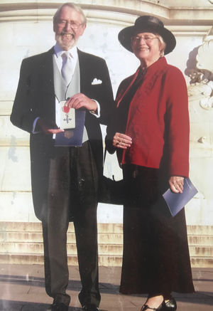 With wife Marylyn on the day of his investiture at Buckingham Palace. 