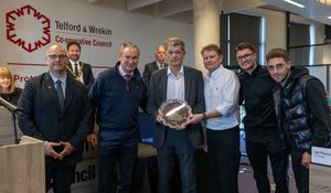 Council leader Lee Carter (left) presents AFC Telford United representatives including manager Kevin Wilkin (second front left) and chairman Ian Dosser (middle) with the award. Picture: Telford & Wrekin Council.