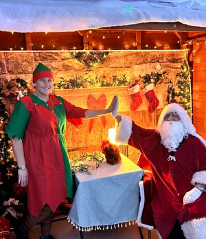 Santa and one of his elves in the grotto in the Strand Hall