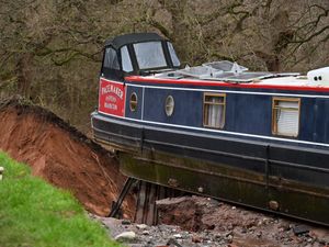 Supporting image for story: Boat left perched on the edge of Whitchurch canal breach rescued in late-night operation