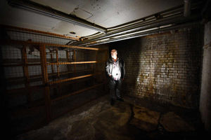 Former member of the Central Youth Theatre Ed O'Driscoll next to old storage shelves at the former Co-operative store