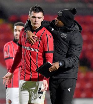 Darren Byfield consoles Oisin McEntee at the final whistle.