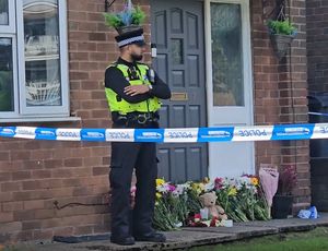 Floral tributes have been left outside the house in Lovett Avenue where the 13-year-old boy was stabbed to death