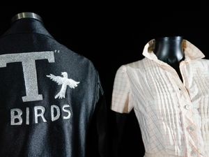 Danny Zuko's T-Birds jacket and Sandy Olsson's dress from the film Grease on display before the Propstore auction in Los Angeles