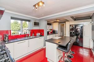 Contemporary kitchen and dining area with modern units and breakfast bar