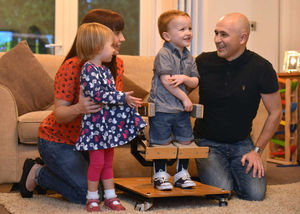 Harry, surrounded by his family, in his standing frame that he uses for stretching etc.