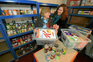 Project manager Jenny Townley and fundraiser and organiser Bridget Supple filling shelves at Newport foodbank