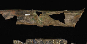 A section of the reconstructed helmet band, depicting a frieze of warriors