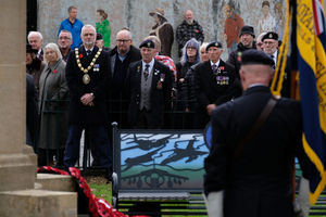 Builth Wells Mayor Councillor Mark Hammond stands with veterans, servicepeople and Royal British Legion members at the service. Pic by Andy Compton