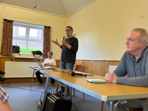 Resident Nick Barnes addressed the audience, next to Councillor Nat Green