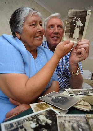 Joyce Onions with Peter Pritchard, with photos of Peter's family that Joyce rescued from a house years ago.