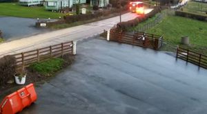 Footage shows the car overtaking the bus on solid white lines.